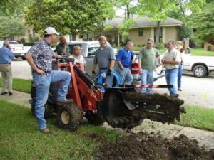 Dania beach sprinkler repair man digs a trench